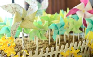 using bird scarers - colorful pinwheels planted on the soil